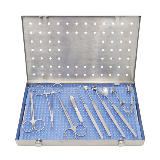 A 10-piece enucleation kit with various surgical instruments, including scissors, forceps, and a speculum, neatly arranged inside an open stainless steel tray with a blue silicone pad.