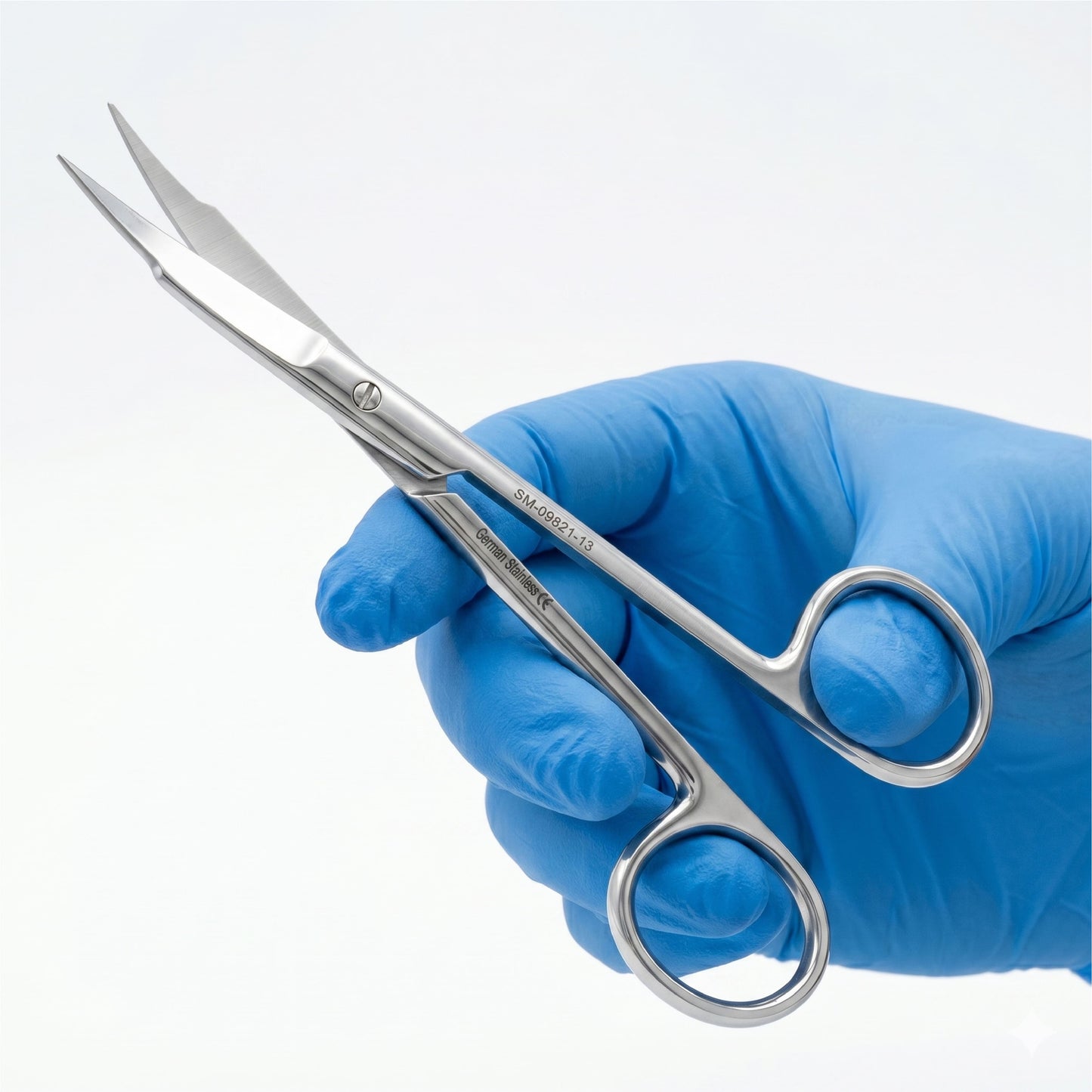 Hand wearing a blue glove holding surgical scissors on a white background