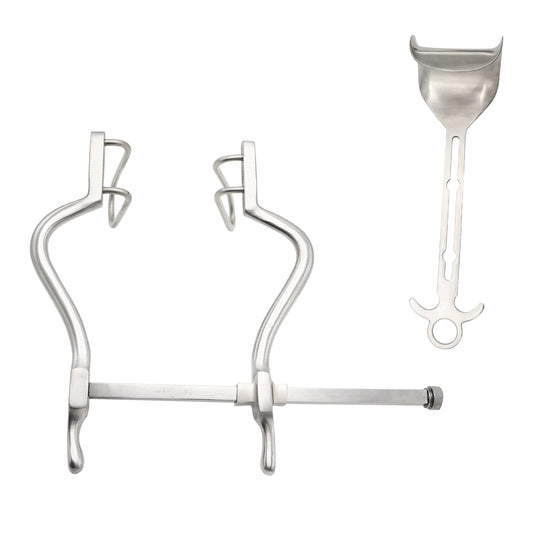 Set of dental tools including a large metal clamp and a smaller scoop on a white background