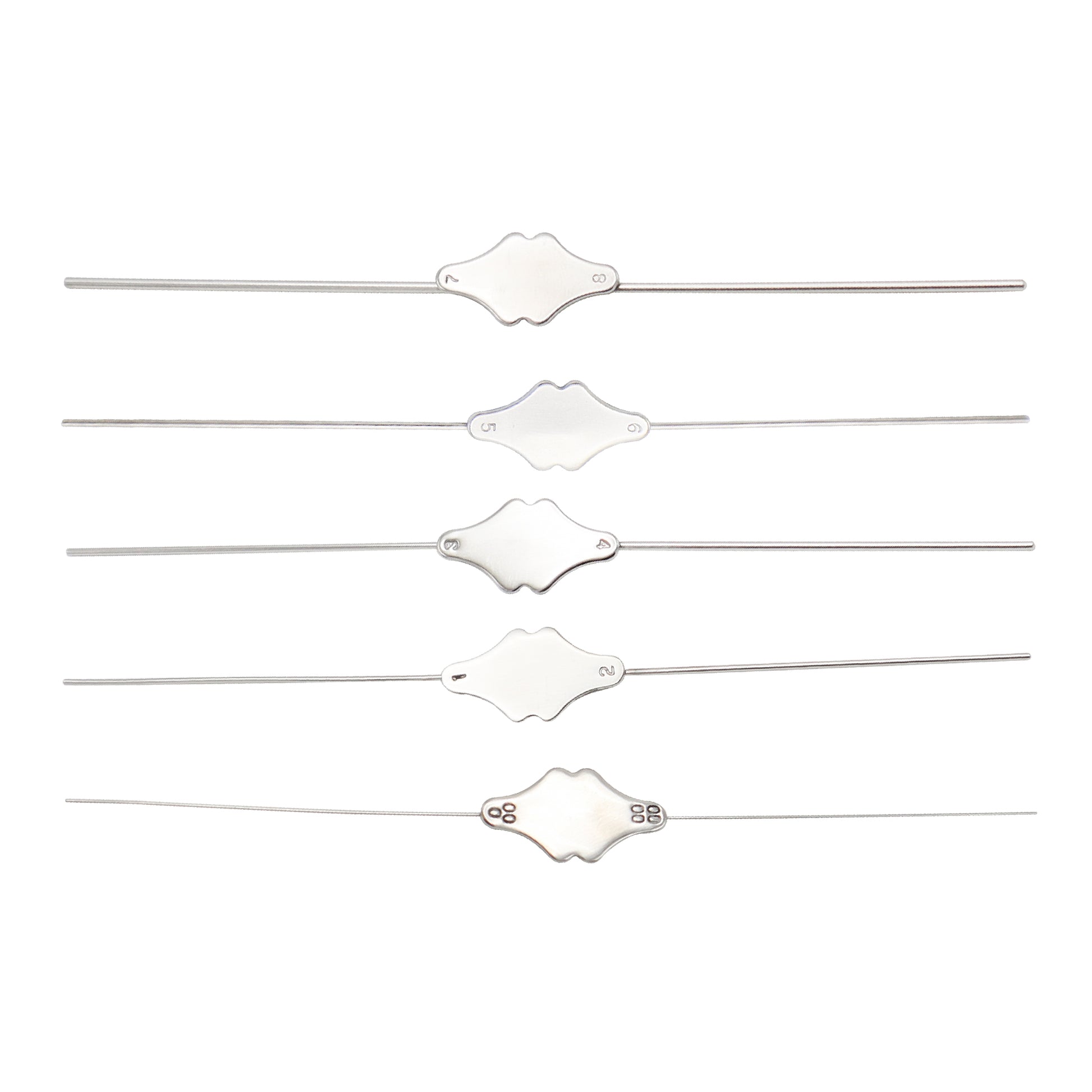 Set of five white hair ties with decorative ends on a white background