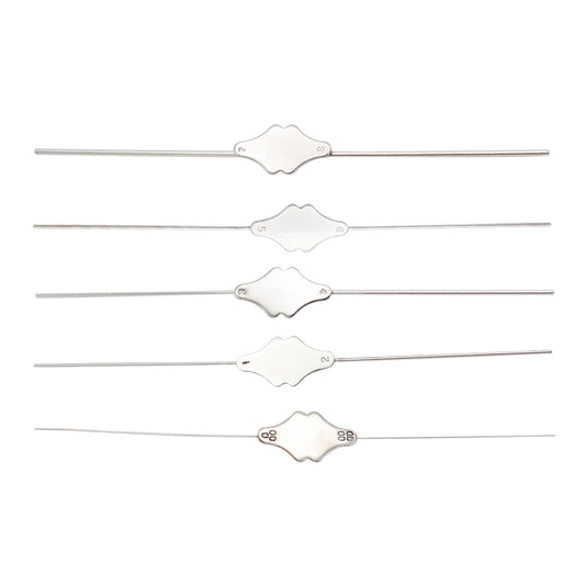 Set of five white hair ties with decorative ends on a white background