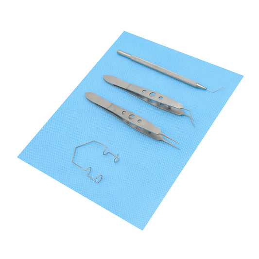 Four specialized eye surgery tools, including a lid speculum, two pairs of precision forceps, and a manipulator probe, laid out on a blue medical cloth.