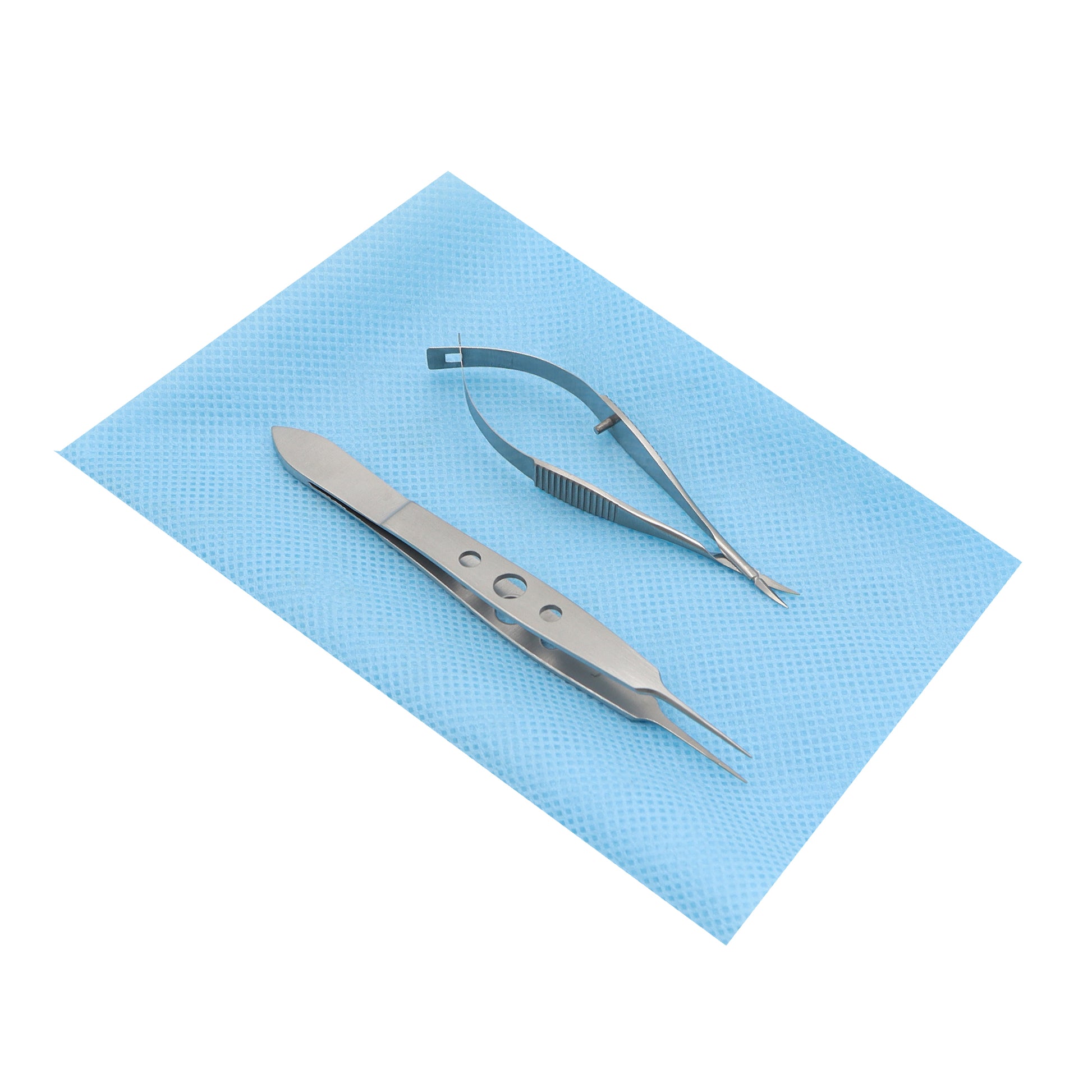 A suture removal set consisting of a straight suture tying forceps and curved Vannas scissors, placed on a blue sterile pad.